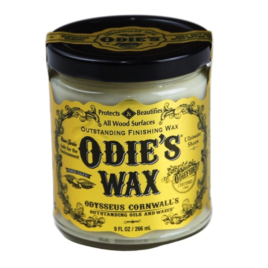 Jar of Odie's Wax with a yellow label on a white background